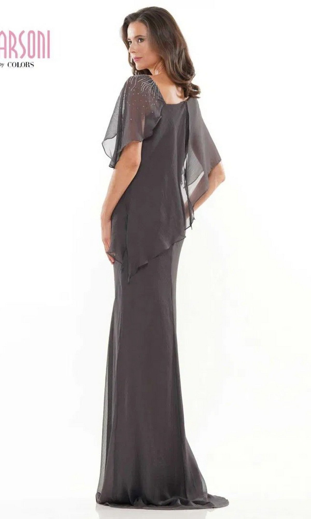 Woman wearing the Marsoni M313 long formal dress with sheer flutter sleeves and delicate beaded details, standing sideways against a white background.